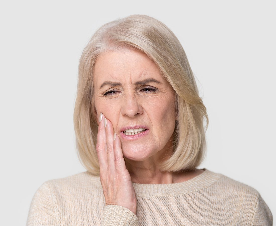 Senior woman experiencing mouth pain
